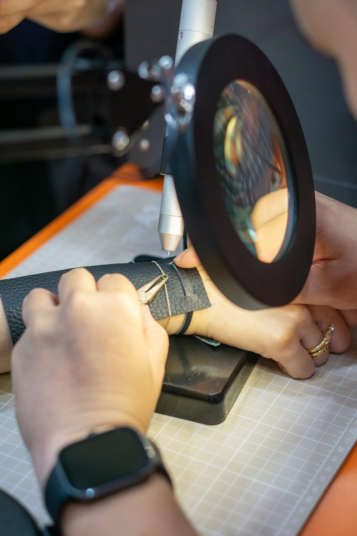 Jeweller inspecting jewellery under a magnifier
