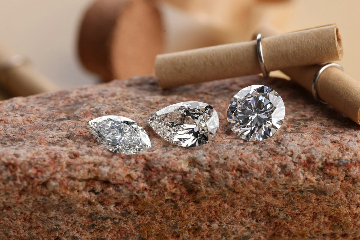 Polished diamonds resting on a rough stone surface