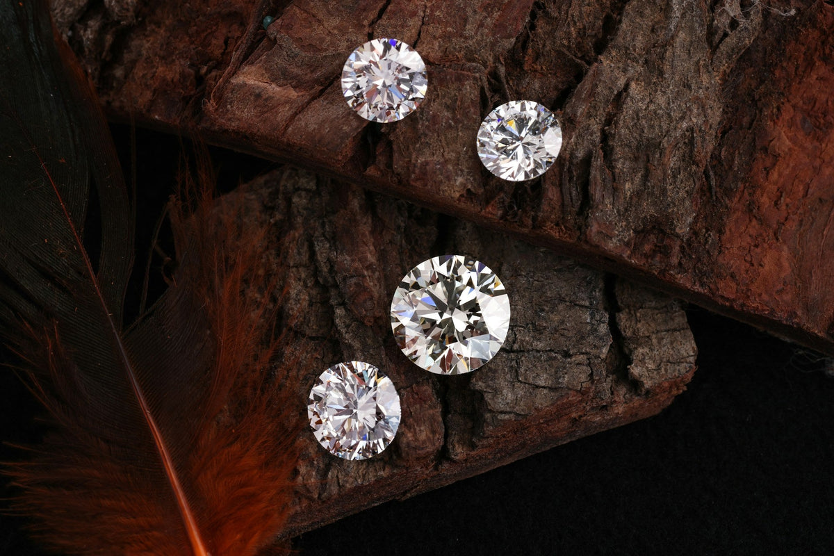 Loose round brilliant diamonds on a rustic wooden surface